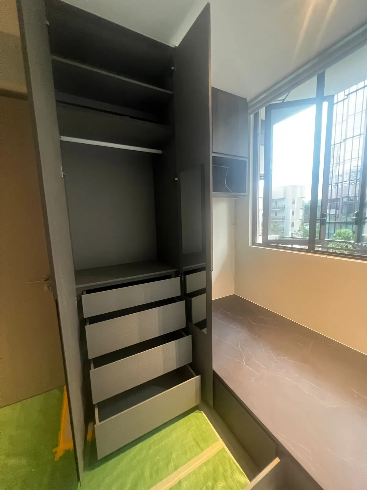 Wardrobe interior with shelves, a hanging rail and four pull-out drawers at Dairy Farm Residences