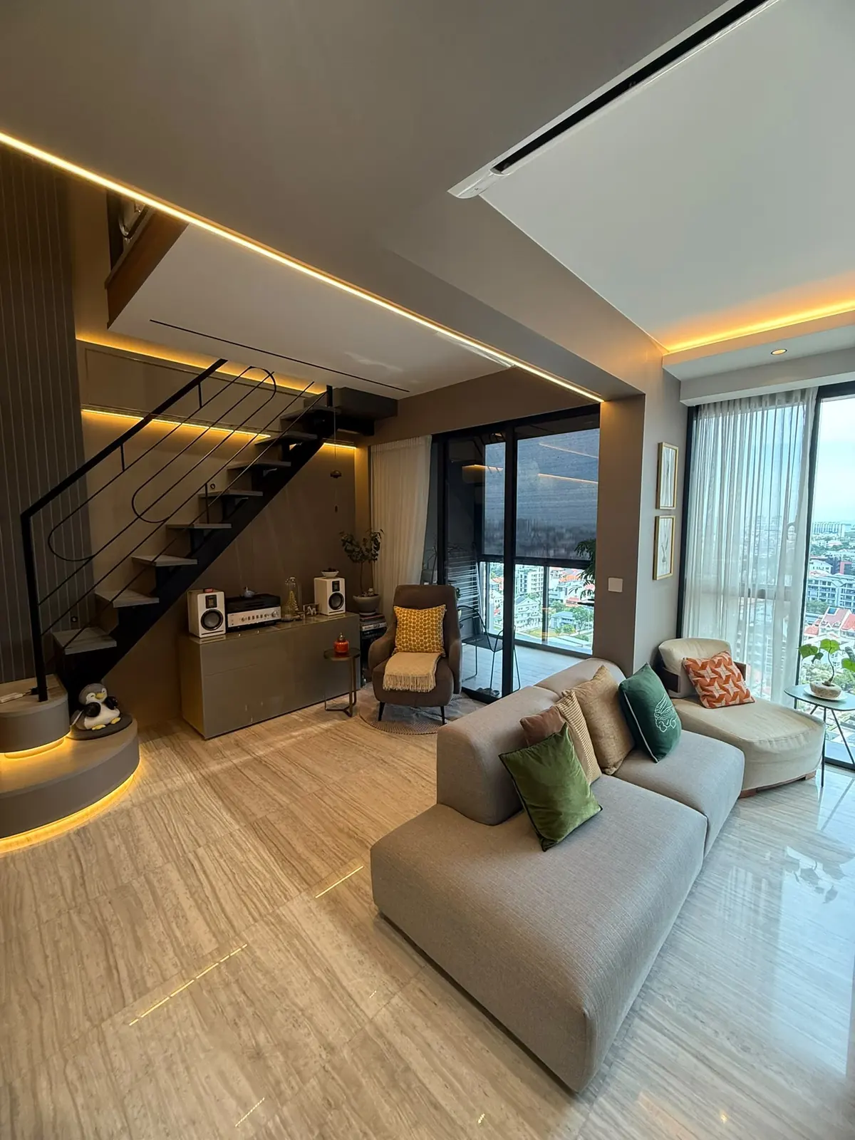 Parc Esta living room with stair, cove lighting and built-in cabinet