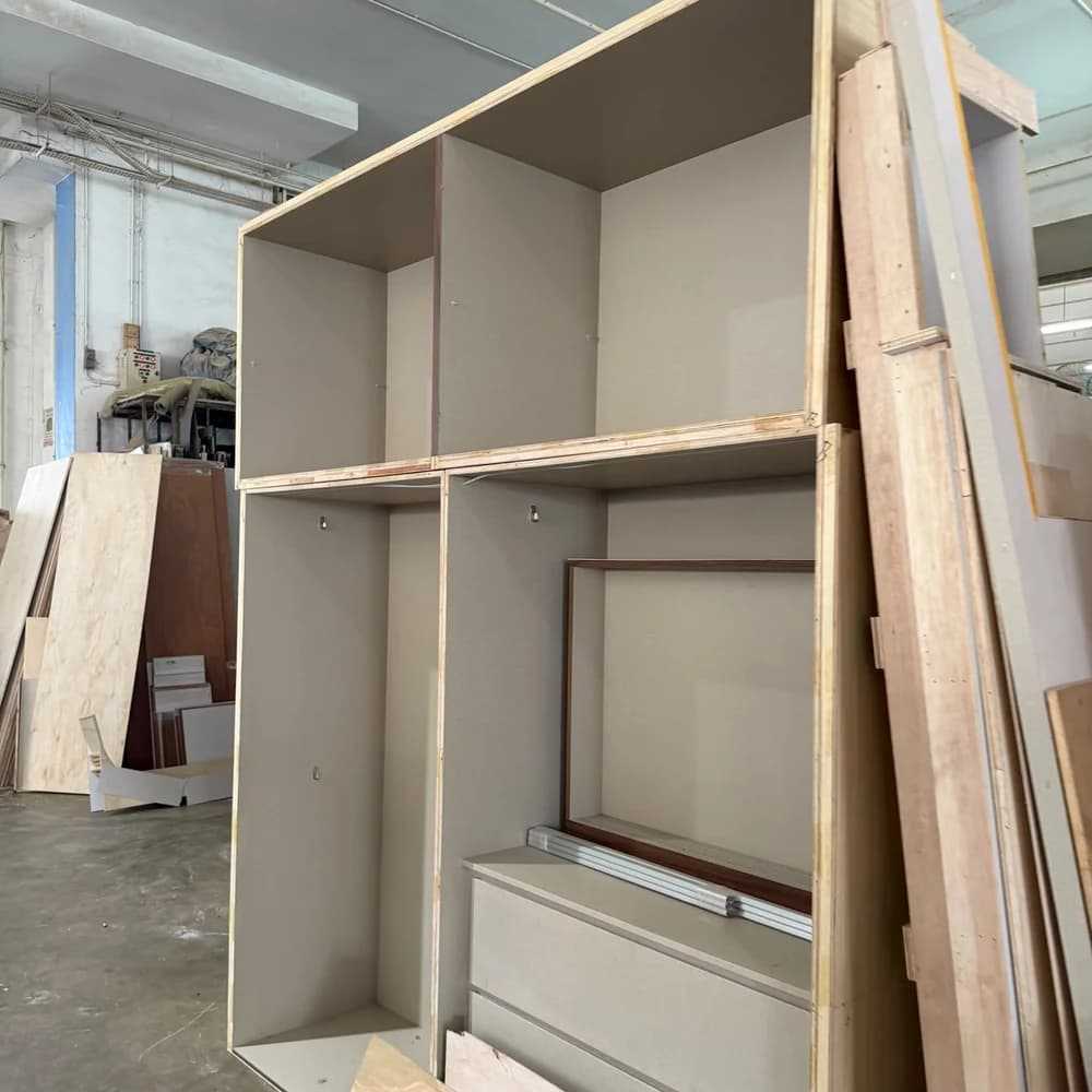 A wardrobe carcass part-built on our factory floor, plywood panels and drawer boxes assembled before finishing