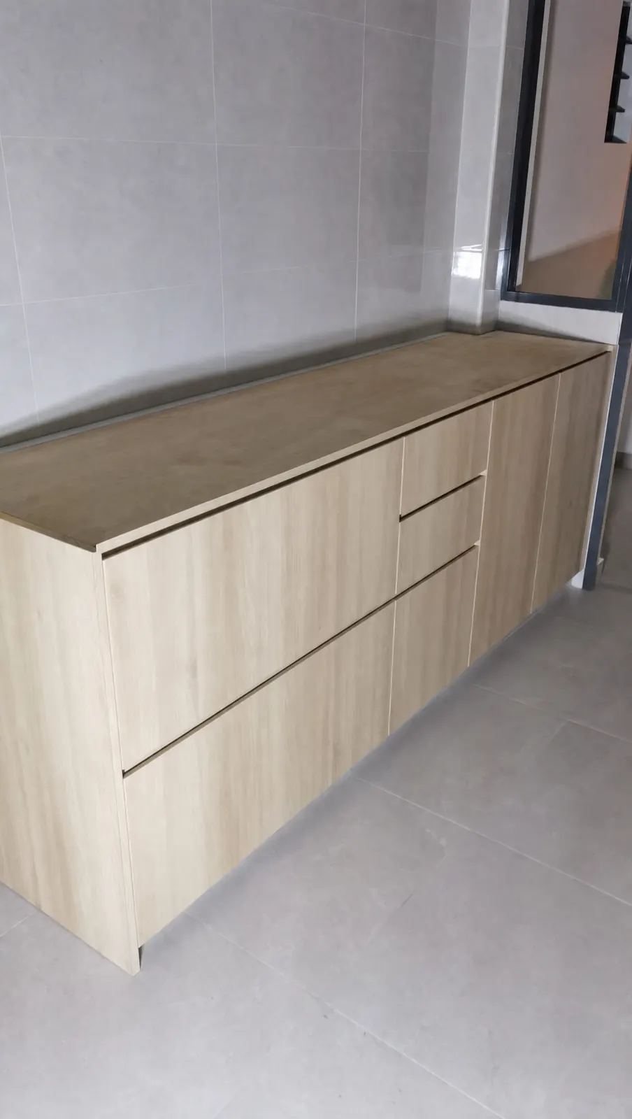 Light oak-look sideboard, a long low cabinet, in a 3-room HDB flat in Punggol